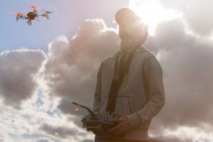 A boy is flying a drone in Switzerland.