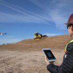 Construction worker flying a drone