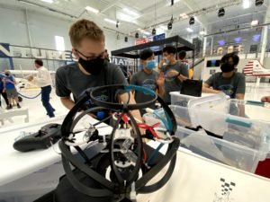 A student prepares for drone soccer